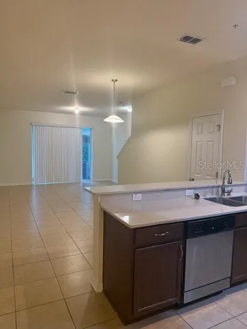 a kitchen with a sink a counter top space and cabinets