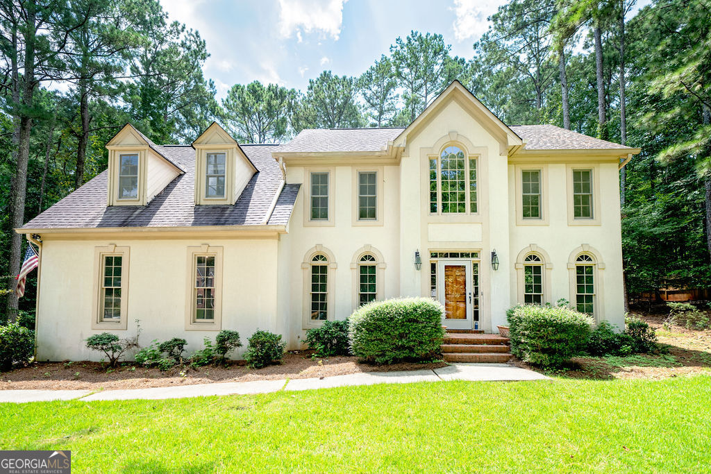 a front view of a house with a yard