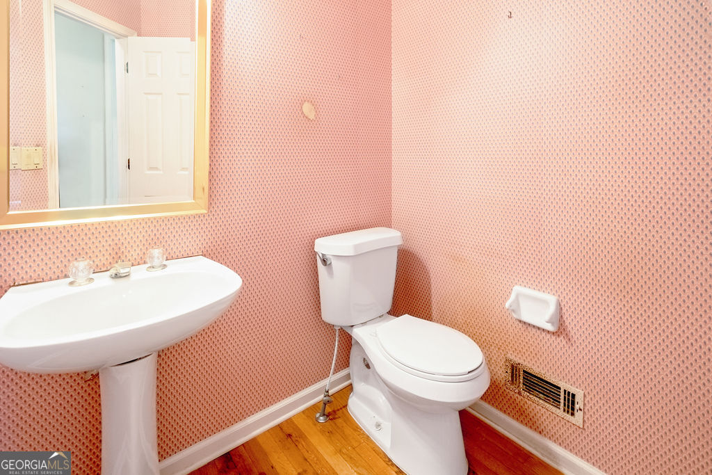 115 Monte Ridge Way Fayetteville, GA 30215 - Photo 15 of 32 a bathroom with a toilet a sink and mirror