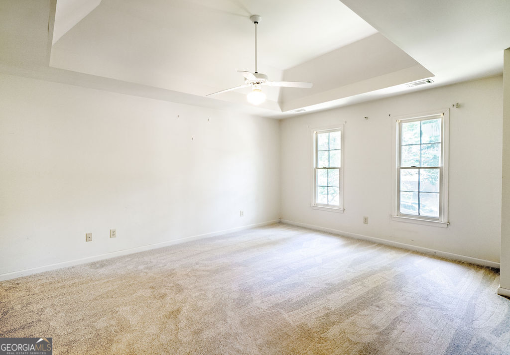 115 Monte Ridge Way Fayetteville, GA 30215 - Photo 17 of 32 an empty room with windows and ceiling fan