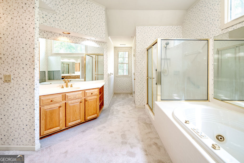 115 Monte Ridge Way Fayetteville, GA 30215 - Photo 19 of 32 a spacious bathroom with a tub sink shower and mirror