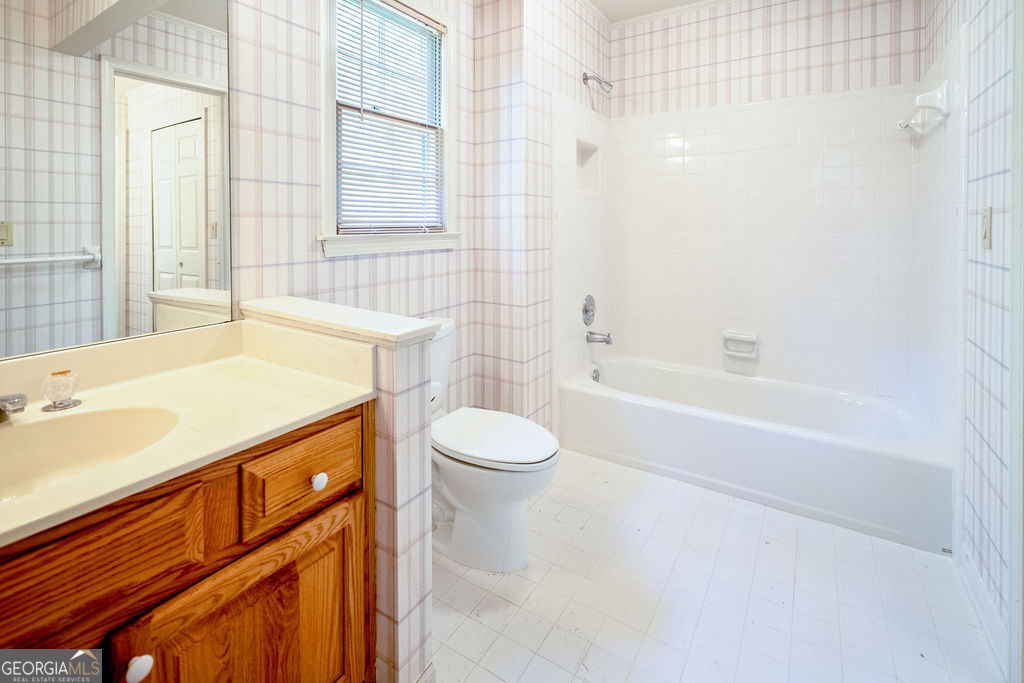 115 Monte Ridge Way Fayetteville, GA 30215 - Photo 25 of 32 a bathroom with a sink a toilet and shower