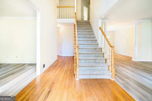 a view of entryway and hall with wooden floor