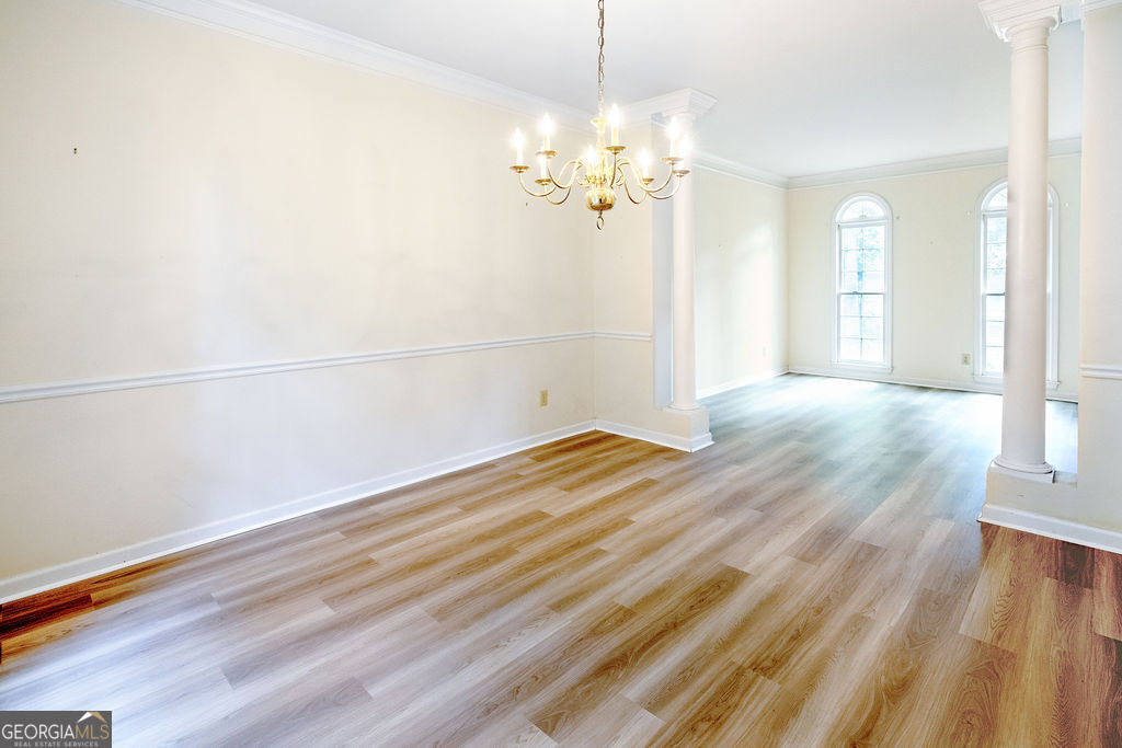 115 Monte Ridge Way Fayetteville, GA 30215 - Photo 7 of 32 a view of a room with wooden floor and chandelier