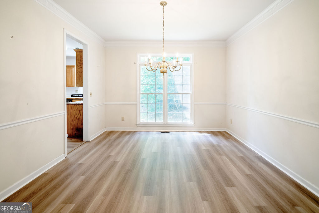 115 Monte Ridge Way Fayetteville, GA 30215 - Photo 8 of 32 wooden floor in an empty room with a window