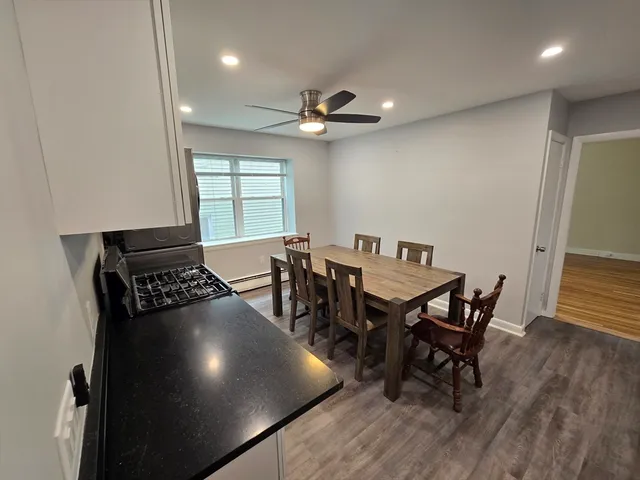 a view of a dining room with furniture and wooden floor