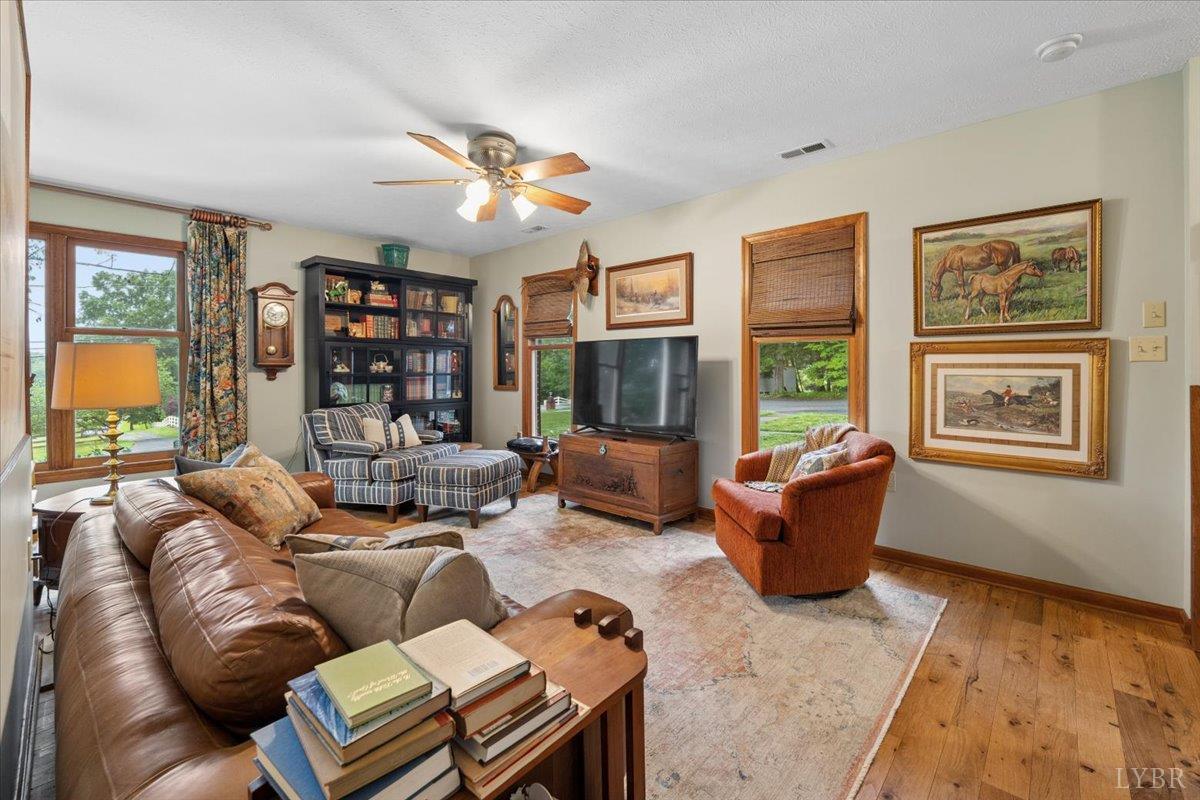 3289 Peaks Road Bedford, VA 24523 - Photo 29 of 71 a living room with furniture a flat screen tv and a large window