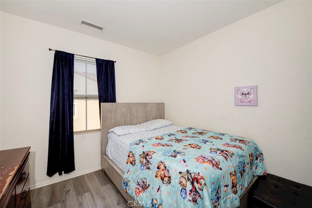 2071 Atlantic Avenue Long Beach, CA 90806 - Photo 10 of 15 a bedroom with a bed and a window