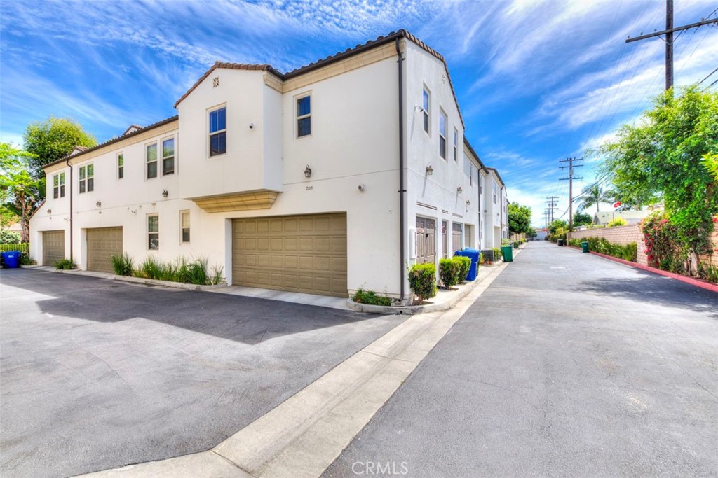 2071 Atlantic Avenue Long Beach, CA 90806 - Photo 12 of 15 a view of a white house with a yard and garage