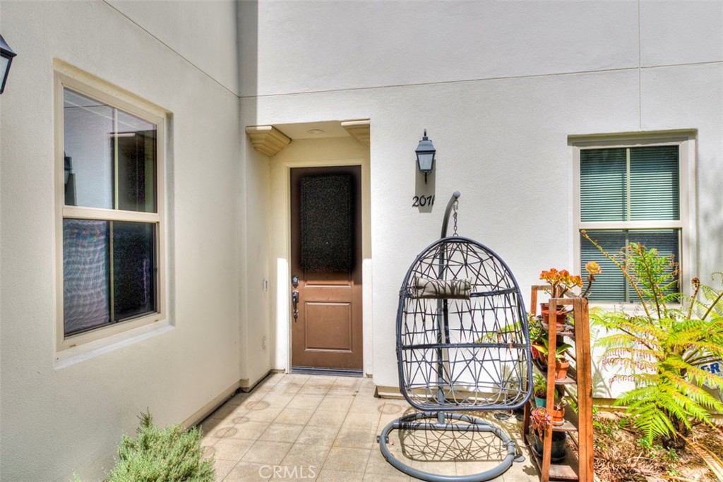2071 Atlantic Avenue Long Beach, CA 90806 - Photo 2 of 15 a view of a hallway with wooden floor windows and a chandelier