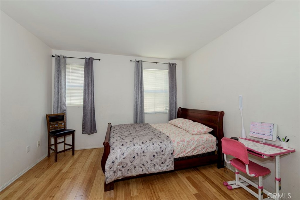2071 Atlantic Avenue Long Beach, CA 90806 - Photo 4 of 15 a bedroom with a bed and a workspace