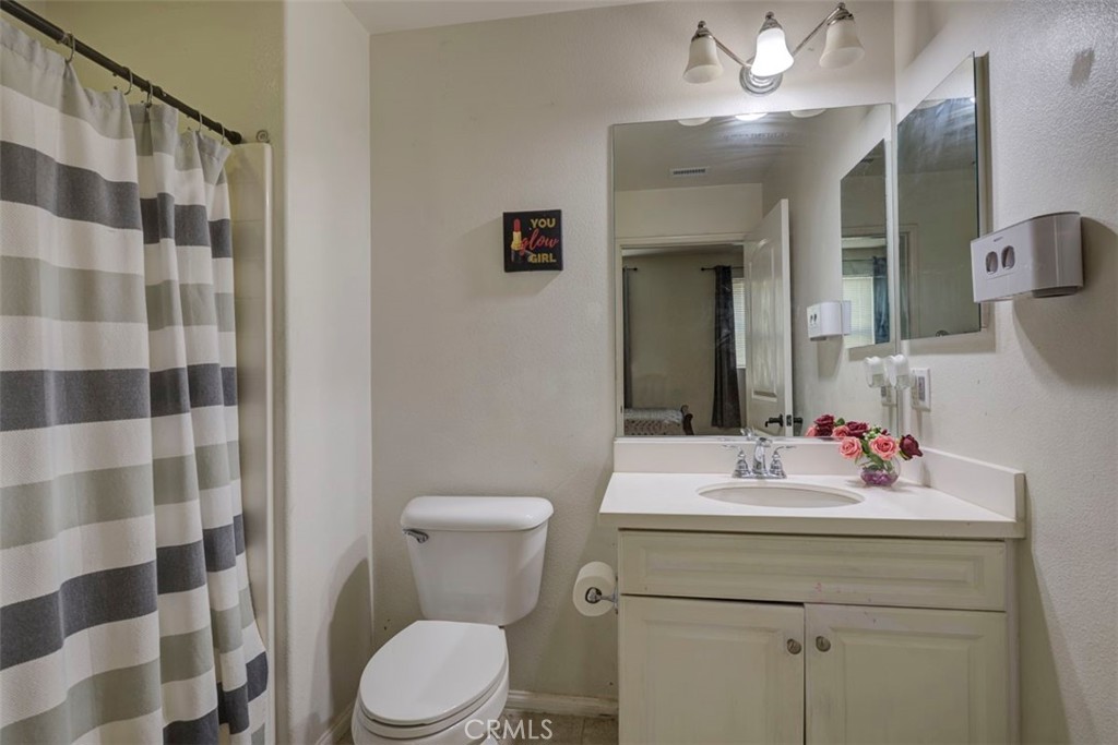 2071 Atlantic Avenue Long Beach, CA 90806 - Photo 5 of 15 a bathroom with a sink toilet and shower