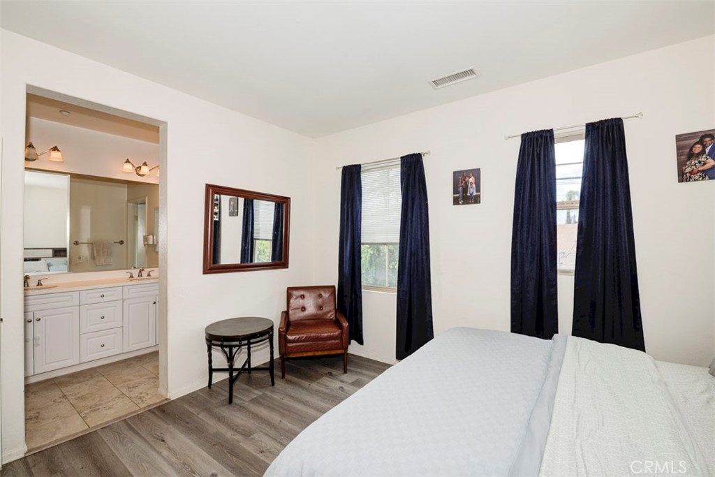 2071 Atlantic Avenue Long Beach, CA 90806 - Photo 9 of 15 a bedroom with a bed and a chandelier
