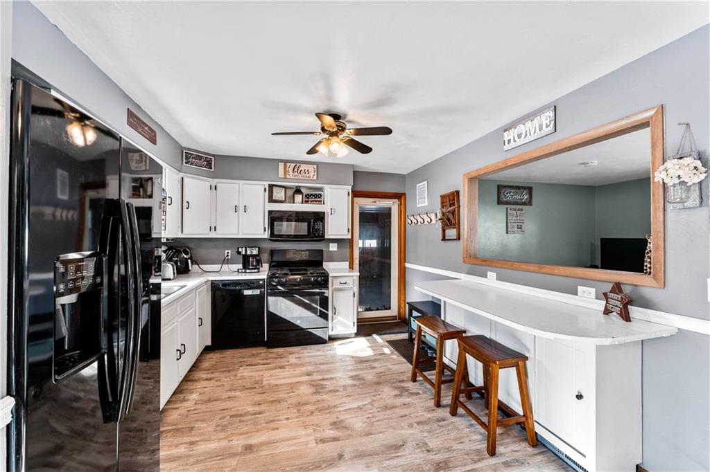 4930 Georgetown Road Franklin, PA 16323 - Photo 8 of 25 a large kitchen with stainless steel appliances a stove a sink dishwasher a refrigerator and a view of living room
