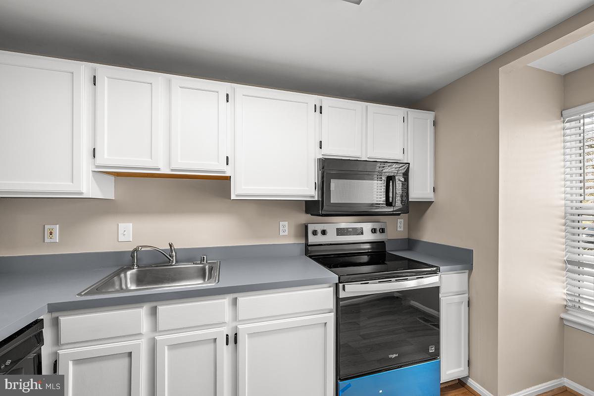 144 Forests Edge Place Laurel, MD 20724 - Photo 2 of 31 a kitchen with white cabinets stainless steel appliances and sink