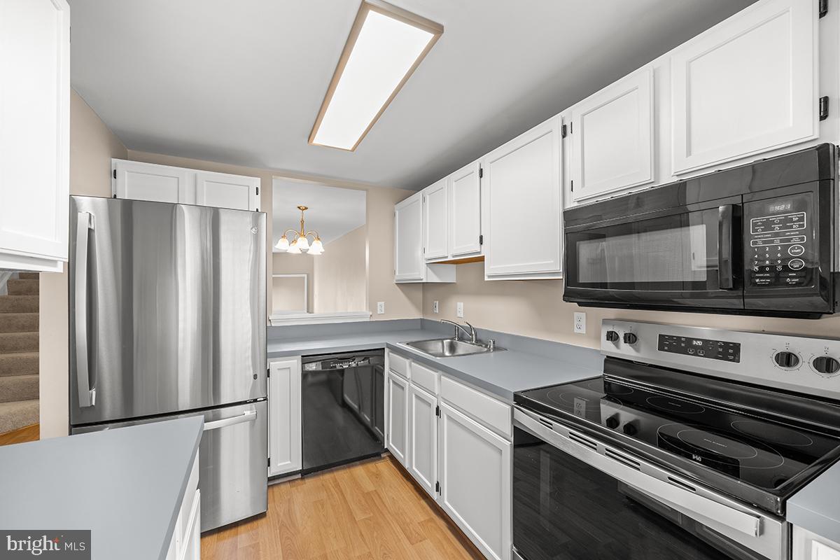 144 Forests Edge Place Laurel, MD 20724 - Photo 4 of 31 a kitchen with stainless steel appliances a refrigerator stove and microwave