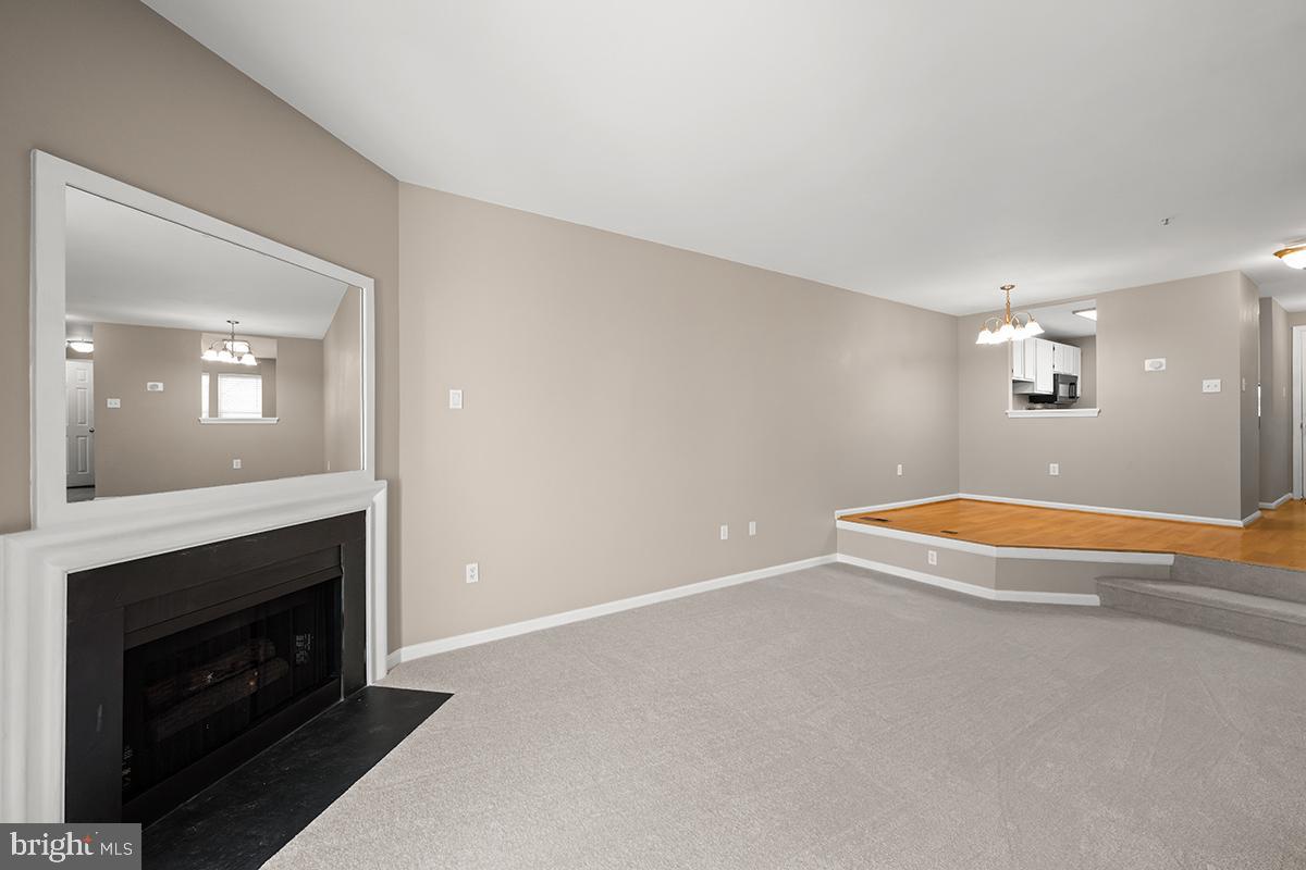 144 Forests Edge Place Laurel, MD 20724 - Photo 10 of 31 an empty room with a fireplace and wooden floor