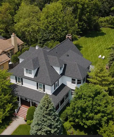 an aerial view of a house with swimming pool and garden