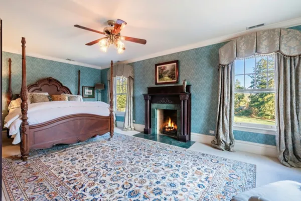 a bedroom with a bed and a fireplace