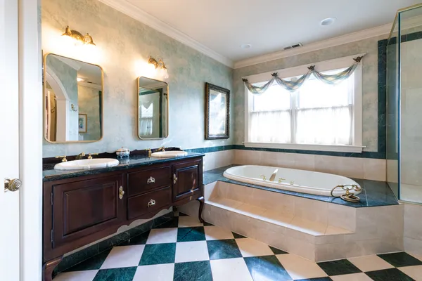a bathroom with a bathtub a sink and a large mirror
