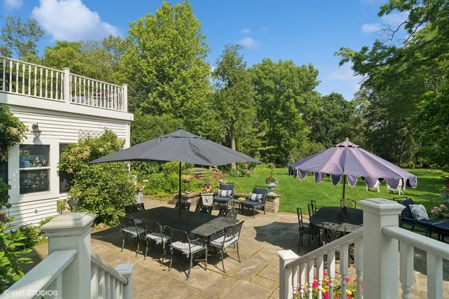 a view of a patio with furniture and a garden