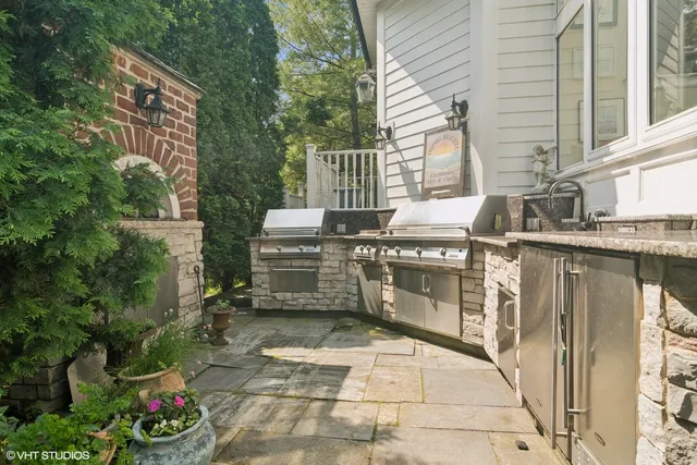 a view of a patio with table and chairs and potted plants