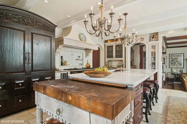 a room with a table chairs and a chandelier