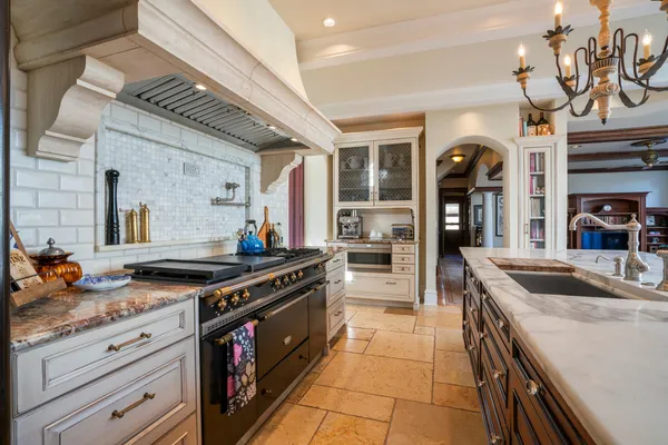 a kitchen with stainless steel appliances granite countertop a stove and a sink