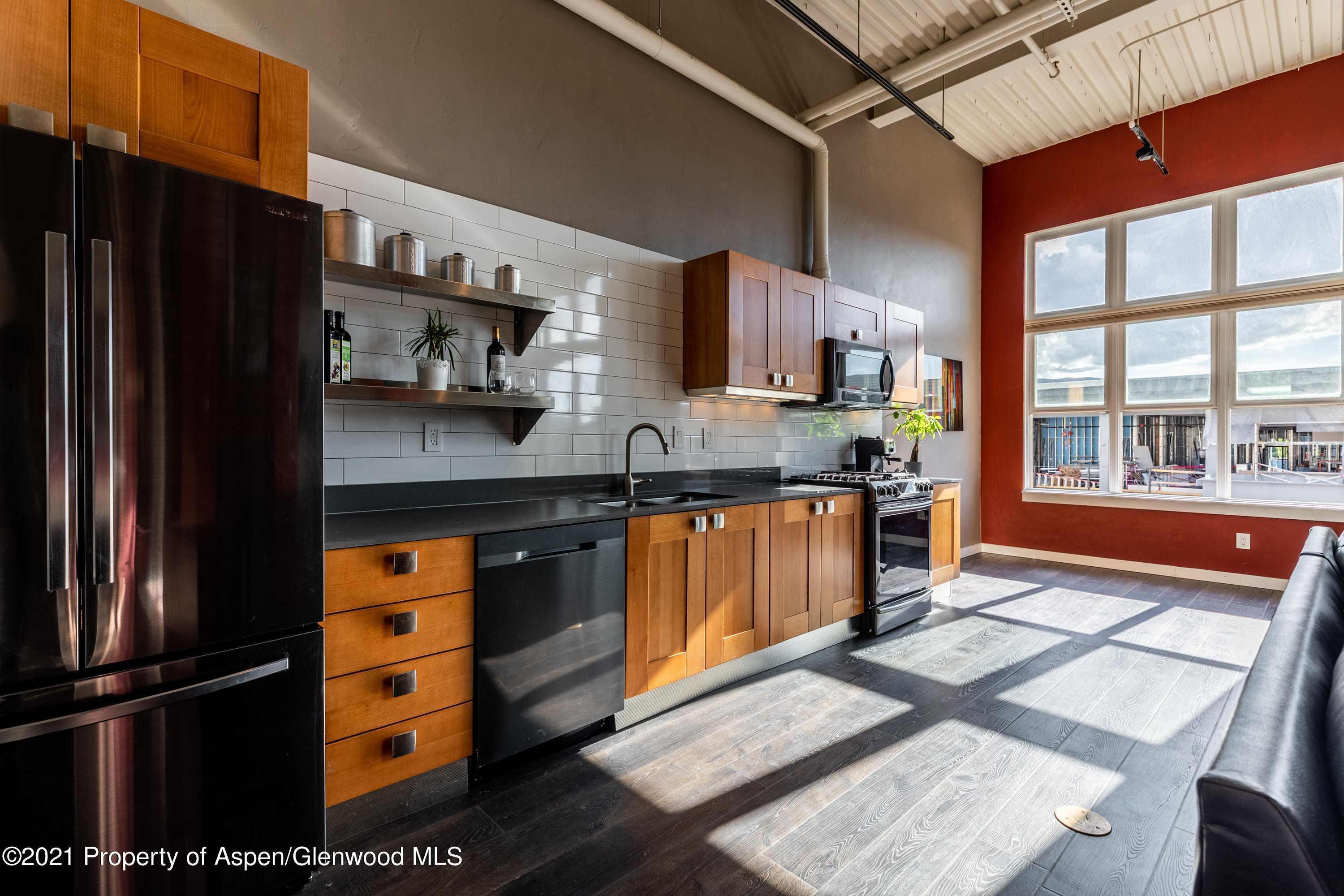 231 Robinson Street, Unit 306 Basalt, CO 81621 - Photo 1 of 15 a kitchen with stainless steel appliances granite countertop a refrigerator a stove a sink and a microwave