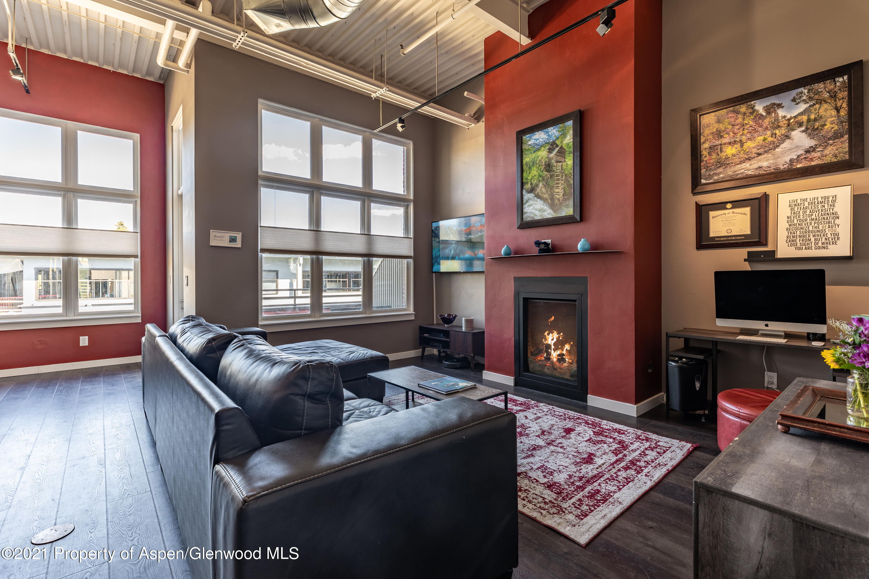 231 Robinson Street, Unit 306 Basalt, CO 81621 - Photo 3 of 15 a living room with furniture and a fireplace