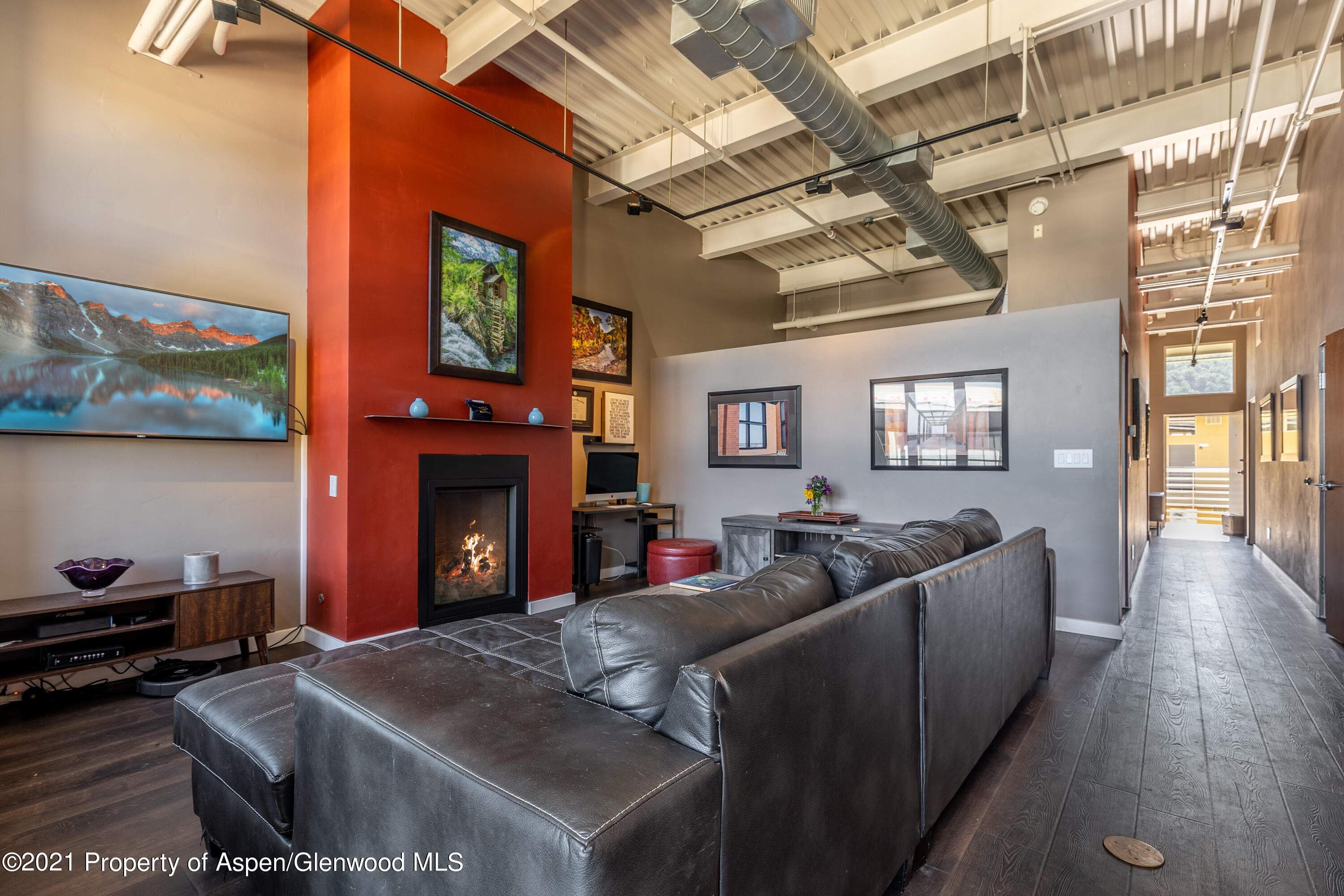231 Robinson Street, Unit 306 Basalt, CO 81621 - Photo 4 of 15 a living room with furniture a fireplace and a flat screen tv