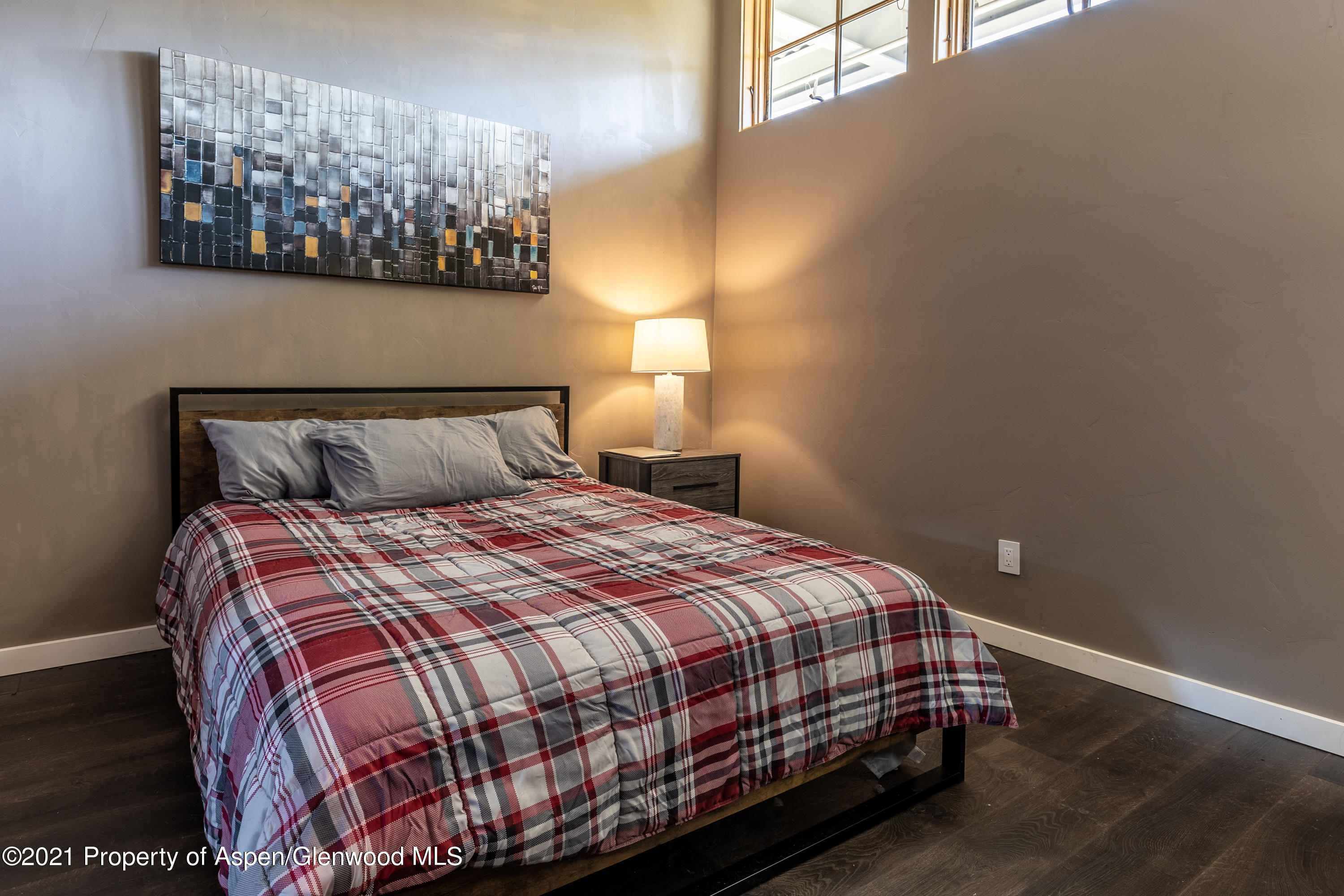 231 Robinson Street, Unit 306 Basalt, CO 81621 - Photo 5 of 15 a bedroom with a bed and painting on the wall