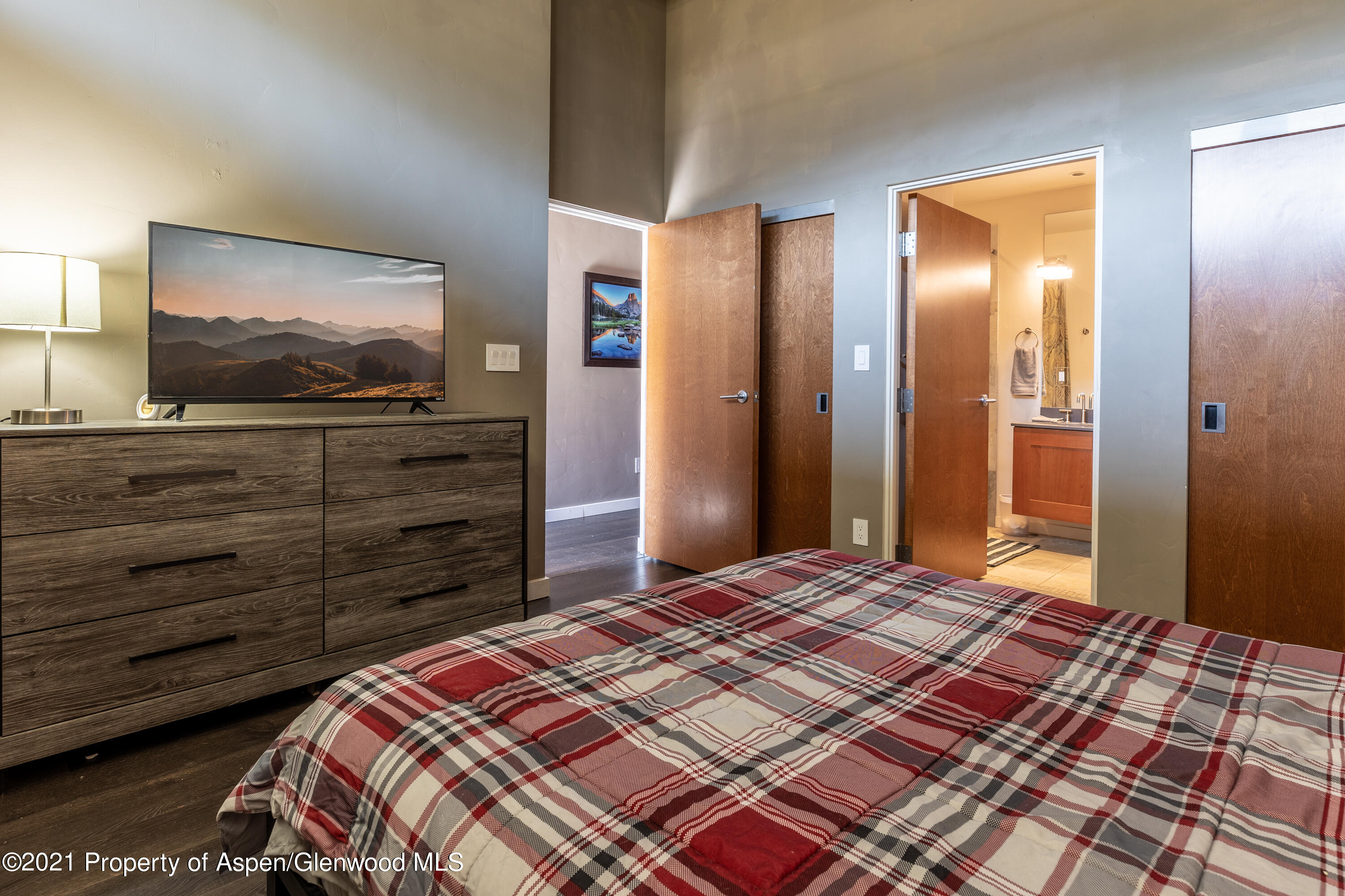231 Robinson Street, Unit 306 Basalt, CO 81621 - Photo 6 of 15 a bedroom with a bed and a mirror on dresser