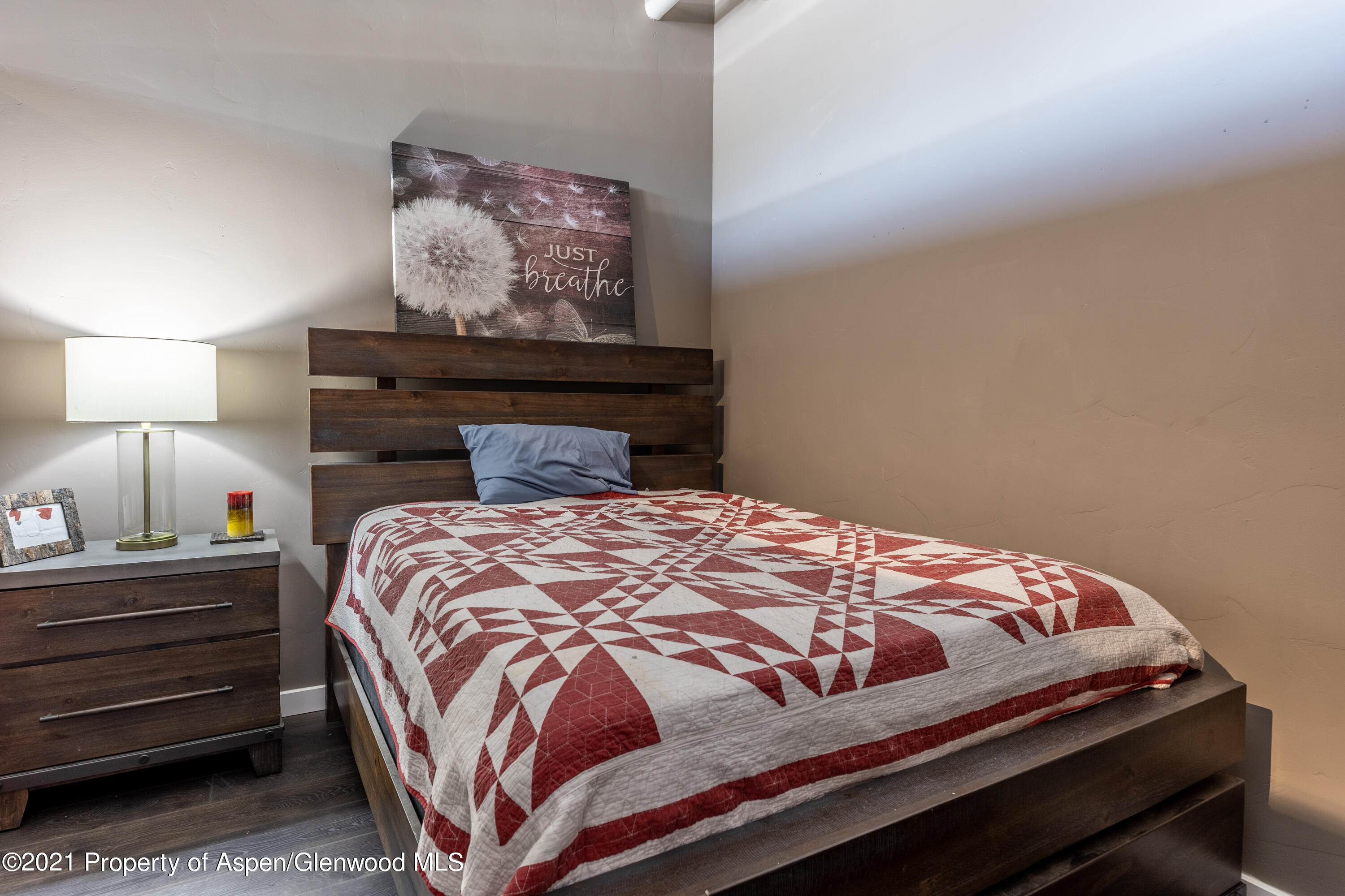 231 Robinson Street, Unit 306 Basalt, CO 81621 - Photo 8 of 15 a bedroom with a bed and painting on the wall