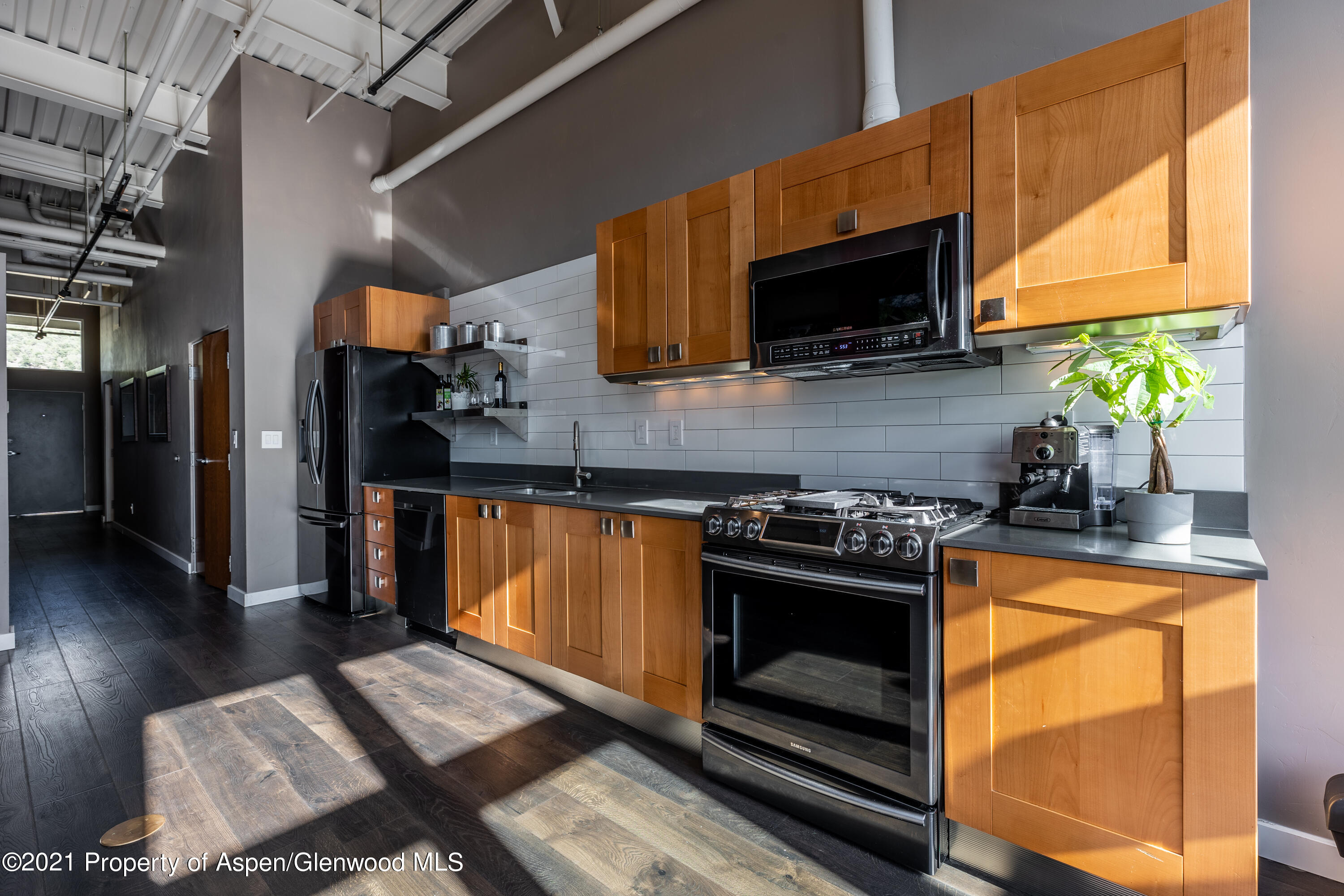 231 Robinson Street, Unit 306 Basalt, CO 81621 - Photo 10 of 15 a kitchen with stainless steel appliances a stove a microwave a sink and a refrigerator