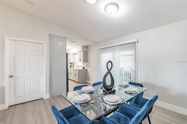 a dining room with furniture and wooden floor