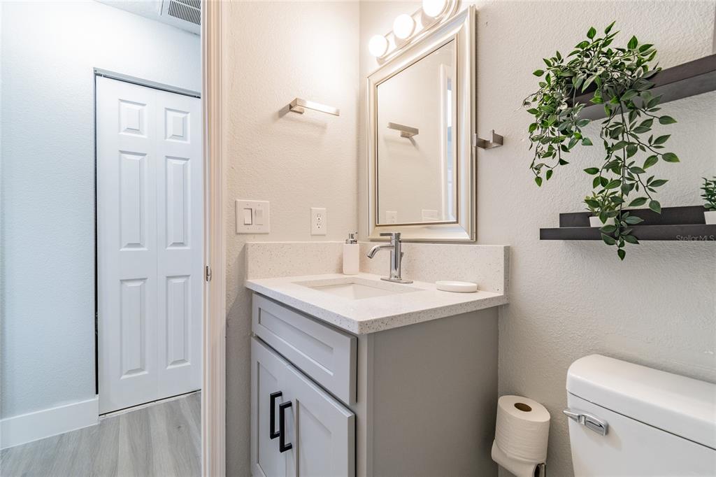 14003 Ridgedale Way Tampa, FL 33625 - Photo 13 of 28 a bathroom with a granite countertop sink a toilet and with mirror