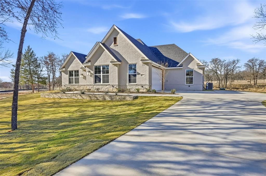 1053 Llano Way Poolville, TX 76487 - Photo 3 of 40 a front view of a house with a ocean view