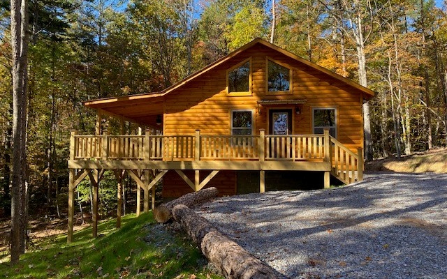 237 Bentley Cove Murphy, NC 28906 - Photo 10 of 35 a backyard of a house with wooden deck and barbeque oven