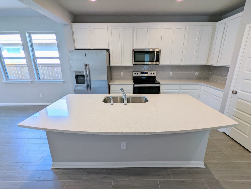 121 Drifter Lane Jarrell, TX 76537 - Photo 2 of 17 a white kitchen with wooden cabinets