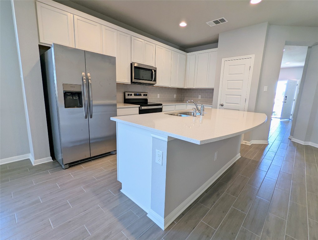 121 Drifter Lane Jarrell, TX 76537 - Photo 4 of 17 a large kitchen with a stove a sink and a refrigerator