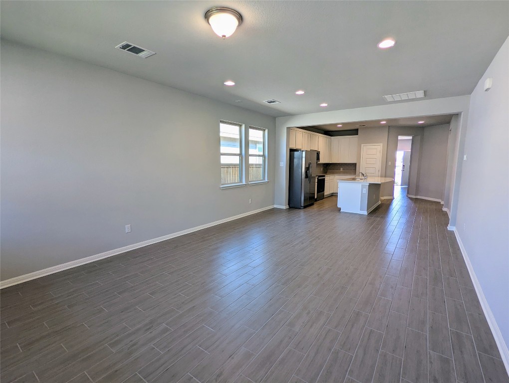121 Drifter Lane Jarrell, TX 76537 - Photo 17 of 17 an empty room with wooden floor and a window