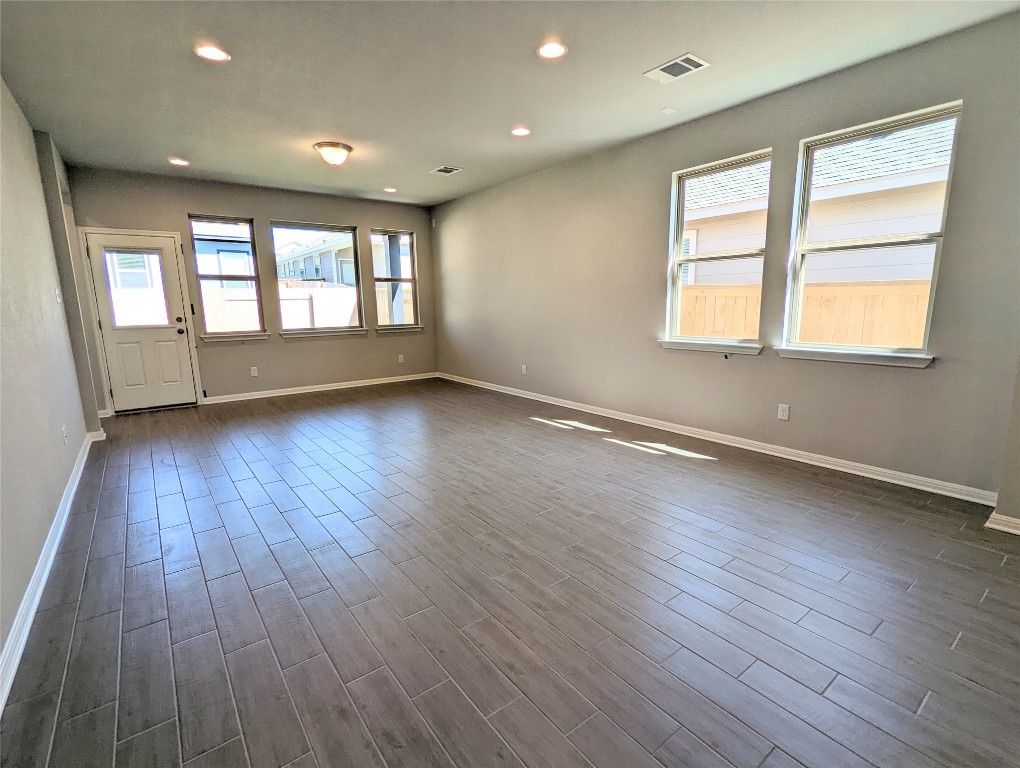 121 Drifter Lane Jarrell, TX 76537 - Photo 6 of 17 an empty room with wooden floor and windows