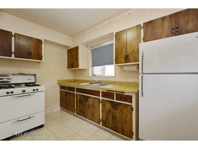 2052 Downey Road Homewood, IL 60430 - Photo 4 of 10 a kitchen with stainless steel appliances granite countertop a refrigerator a stove and a sink with wooden floor