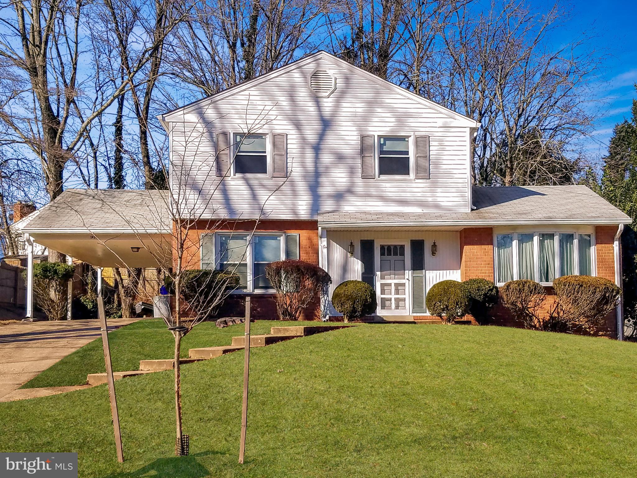 1813 Snowdrop Lane Silver Spring, MD 20906 - Photo 1 of 4 a view of a white house with a yard patio and a garden