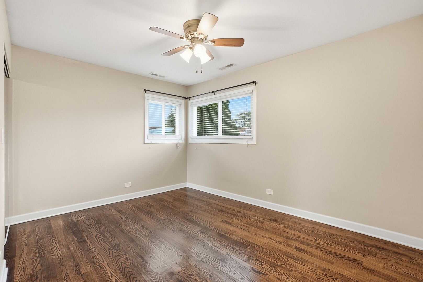 8718 Cranbrook Lane Bridgeview, IL 60455 - Photo 8 of 24 wooden floor in an empty room with a window