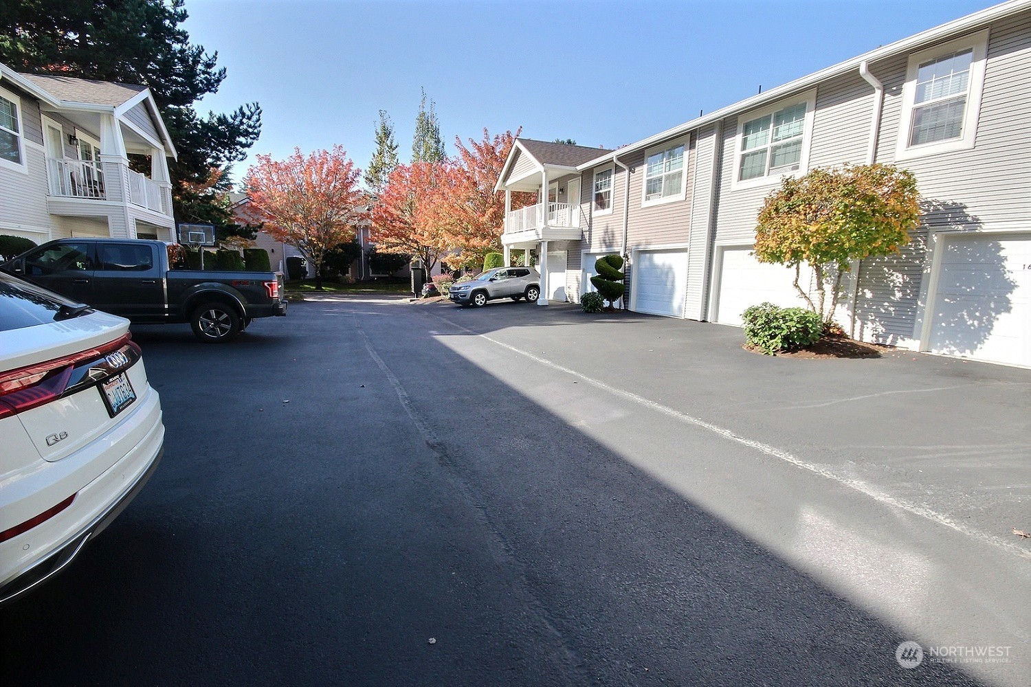1826 Kennedy Place, Unit D7 DuPont, WA 98327 - Photo 18 of 19 a city street lined with parked cars and buildings