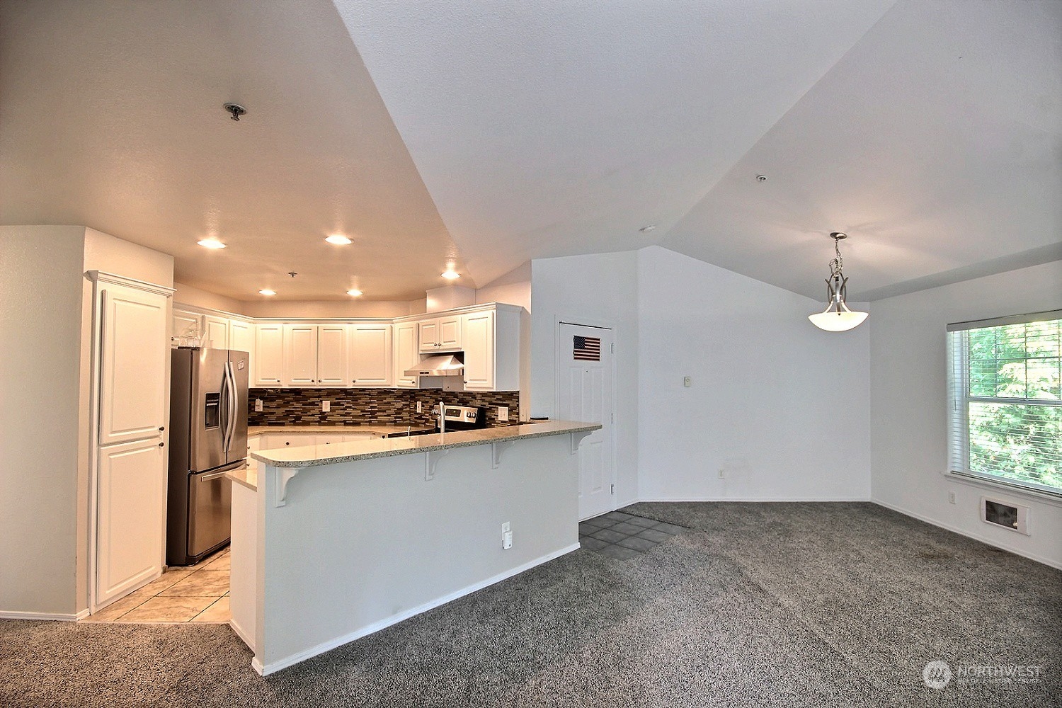 1826 Kennedy Place, Unit D7 DuPont, WA 98327 - Photo 4 of 19 a kitchen with stainless steel appliances a refrigerator and a stove top oven