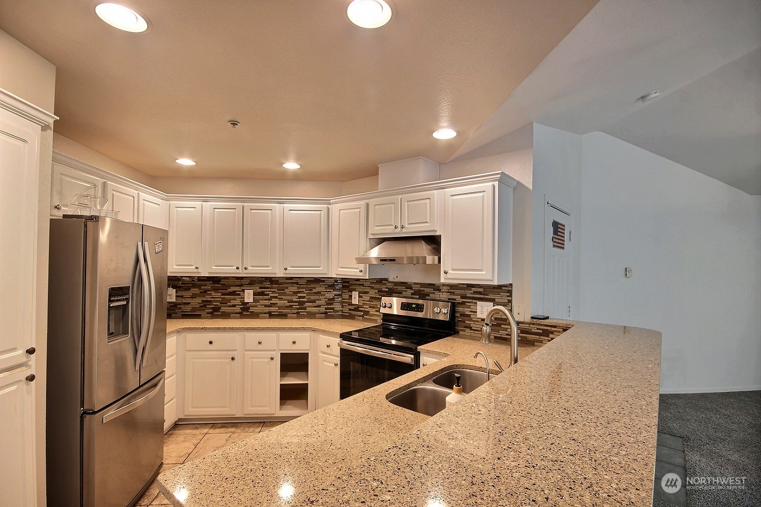 1826 Kennedy Place, Unit D7 DuPont, WA 98327 - Photo 5 of 19 a kitchen with stainless steel appliances granite countertop a sink stove and refrigerator