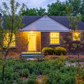 a front view of a house with a yard table and chairs